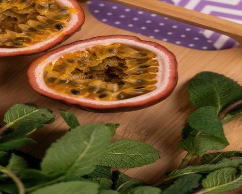 Passion fruit cut in half on a rustic surface